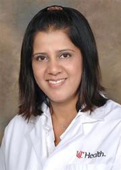 Woman smiling in her UC health uniform